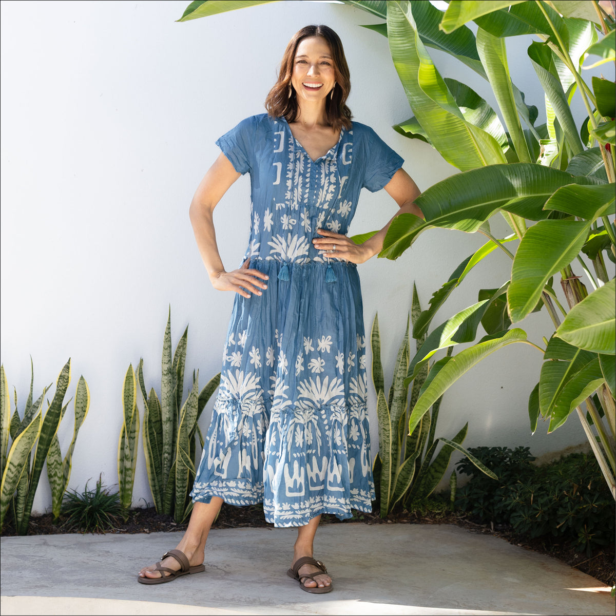 Brunette woman in a blue and white print no-iron crinkle cotton travel dress 