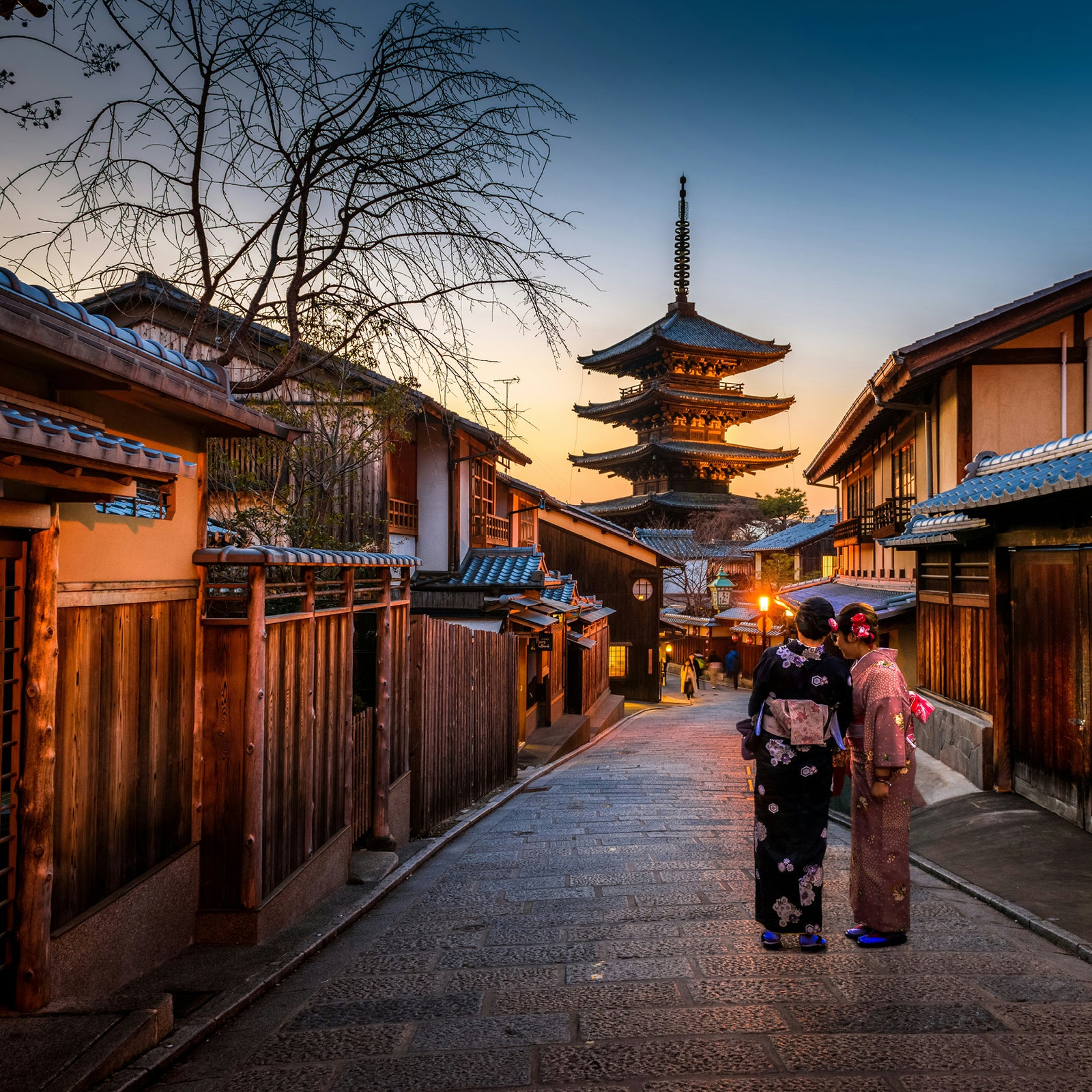 Dusk in Japan during autumn / winter months. Two women in traditional dress.