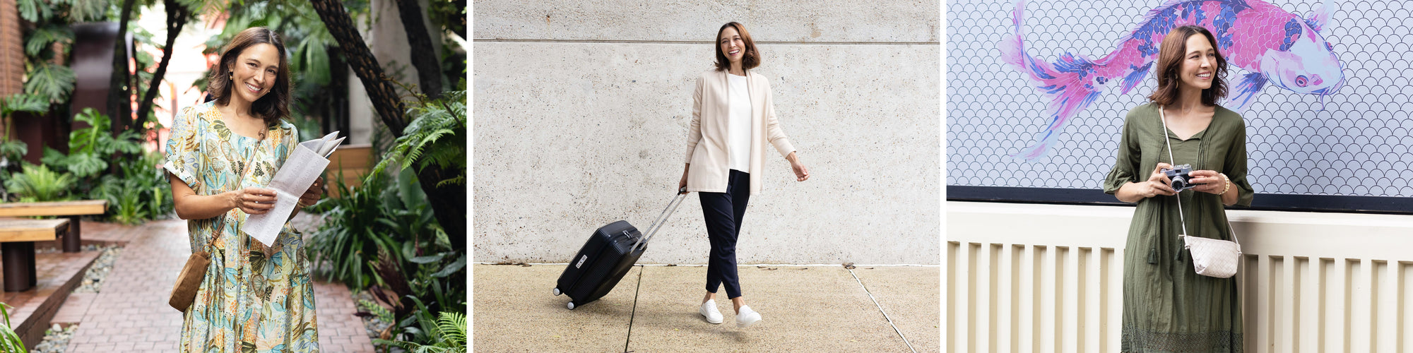 Brunette woman who is travelling, pictured  smiling with a suitcase, tourist information and a camera.