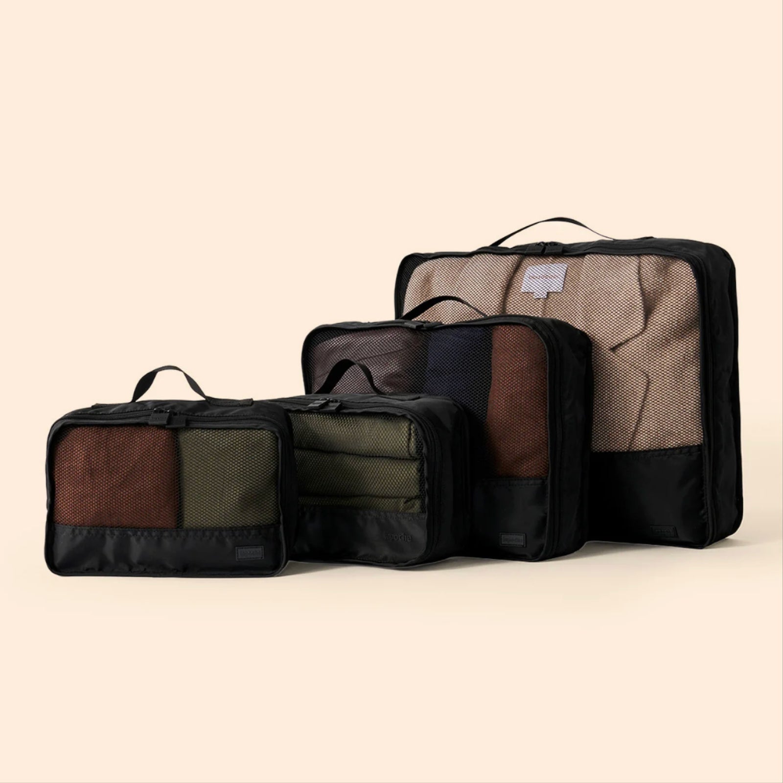 Travel packing cubes showing the way they can be used to organise clothing and accessories in a suitcase.
